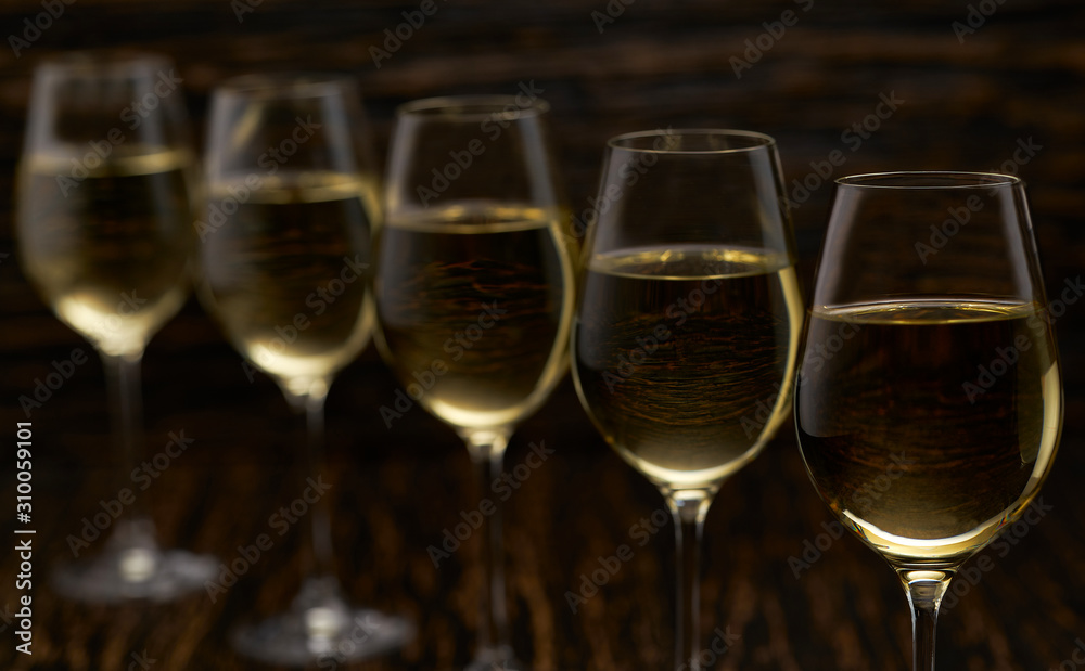 white wine on a black wooden background, close up. white wine on a black wooden background, close up.