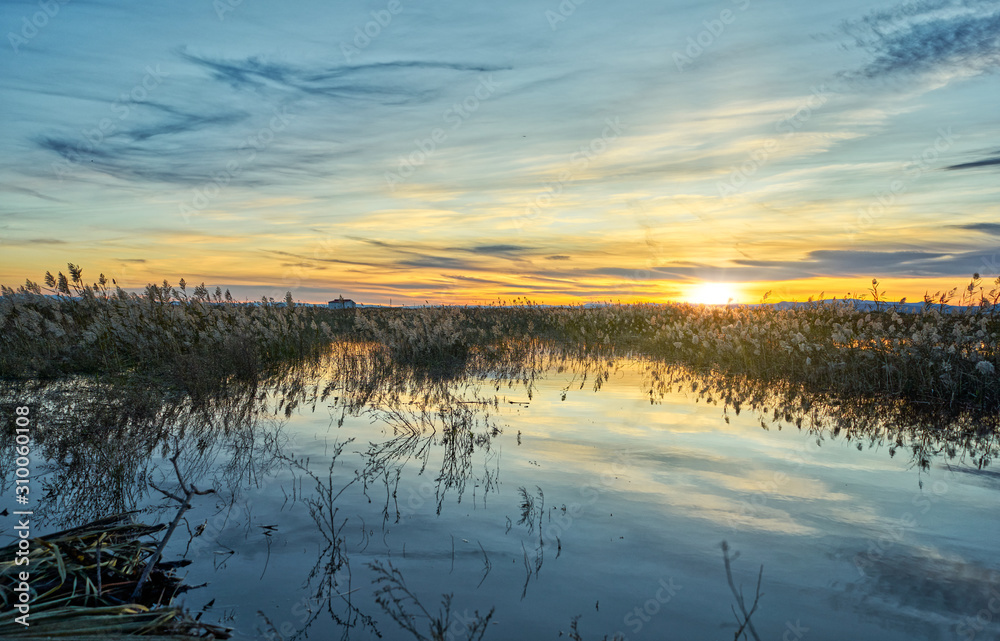 Sunset in the calm waters of the Albufera de Valencia, Spain.
