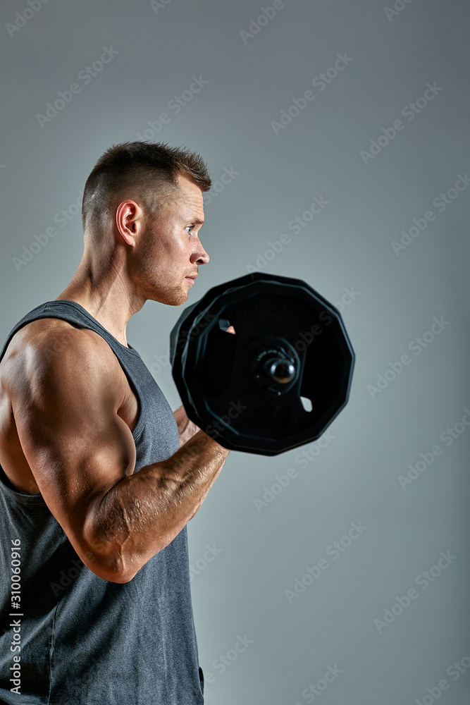 Man doing back workout, barbell row in studio over gray background. Copy space Man doing back workout, barbell row in studio over gray background. Copy space