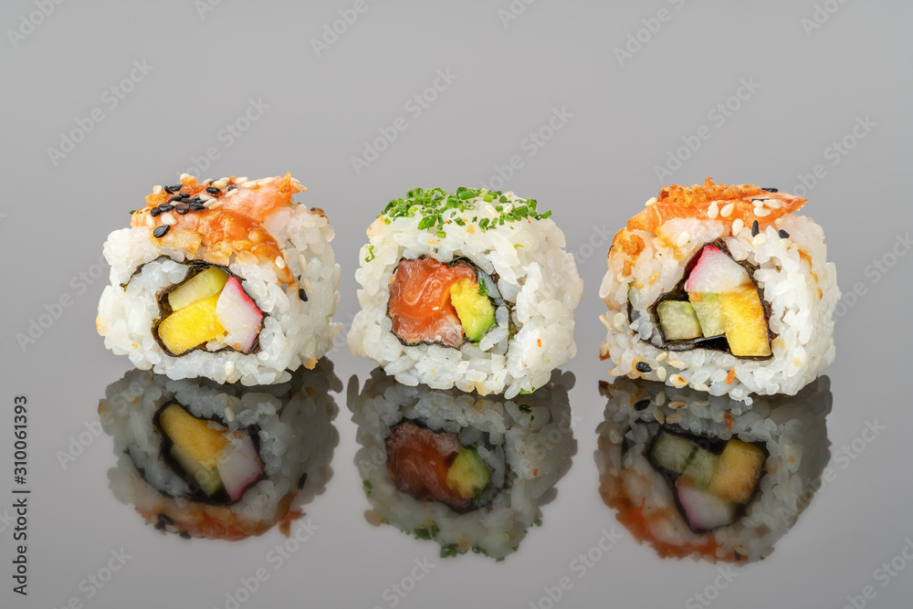 Japanese food sushi rolls uramaki in reflection close-up. Japanese food sushi rolls uramaki in reflection close-up.