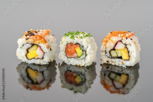 Japanese food sushi rolls uramaki in reflection close-up.