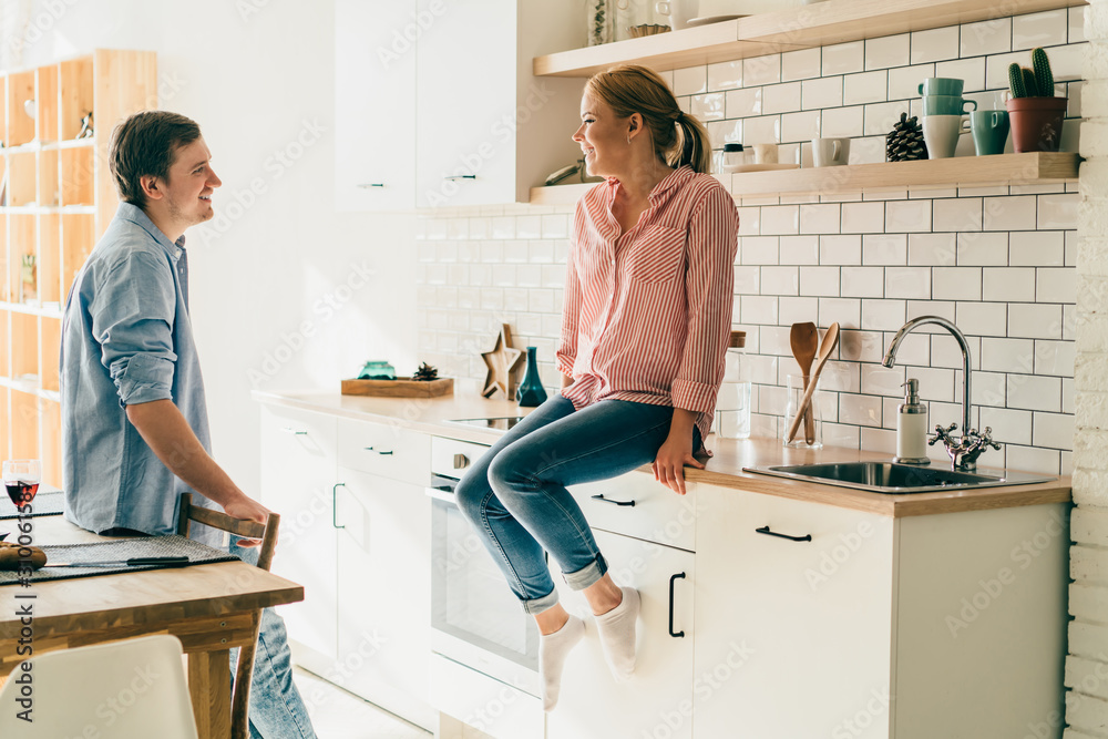 Cheerful young couple in kitchen Cheerful young couple in kitchen