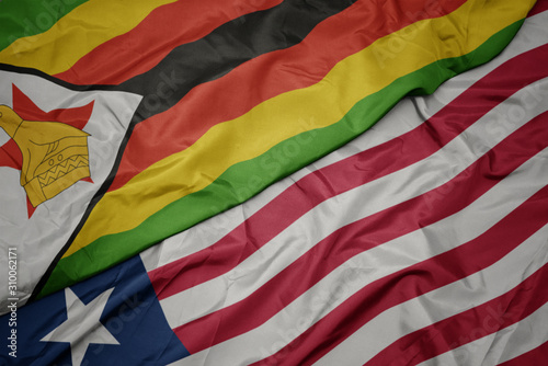 waving colorful flag of liberia and national flag of zimbabwe.