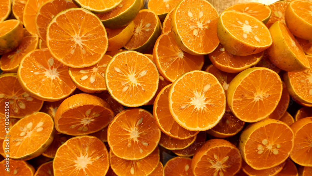 close up oranges cut in half, arranged in groups. close up oranges cut in half, arranged in groups.