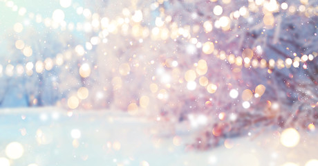 Christmas blurred background. Xmas trees with snow decorated with garland lights, holiday festive background. New year Winter art design, Christmas scene holiday blur forest backdrop