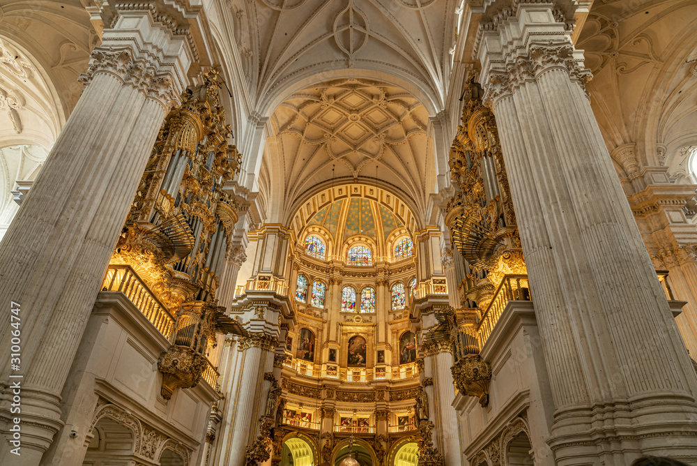 Golden decorations found inside the Cathedral of Granada. Elaborate ornamental grandeur used in the Granada Royal Cathedral, Spain