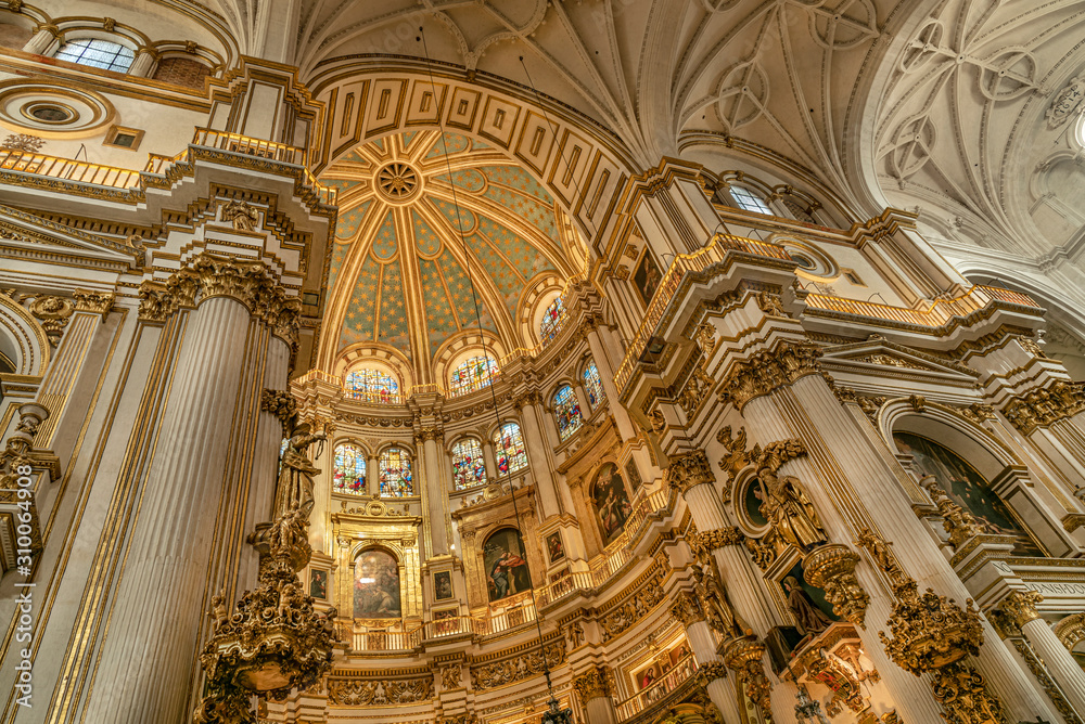 Magnificent golden dome inside the Granada Cathedral in Spain. Interior decoration found in the Granada Royal Cathedral