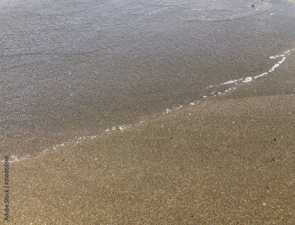 Close up of sandy beach. Summer sunny day, water background Close up of sandy beach. Summer sunny day, water background