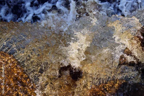 water stream cascade falling on the rocks close up © Mokrousov Boris