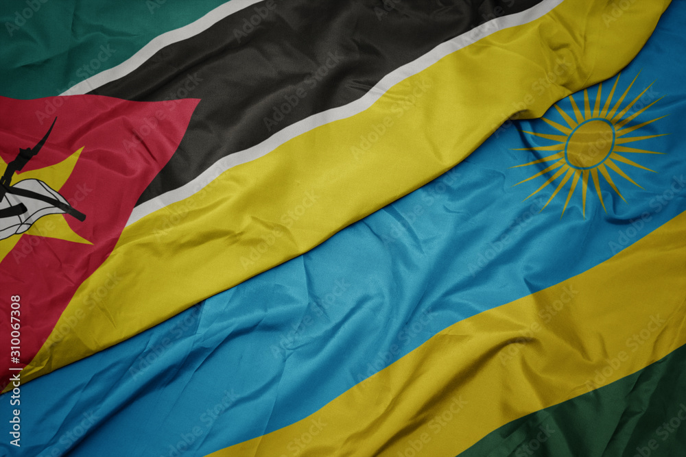 waving colorful flag of rwanda and national flag of mozambique. waving colorful flag of rwanda and national flag of mozambique.