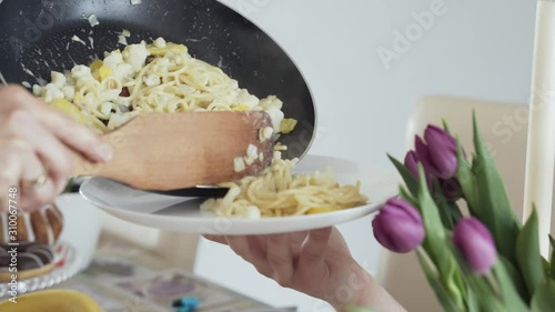 putting food from the pan on a plate