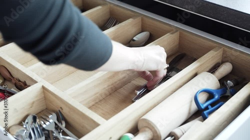 pulling the cutlery out of the cutlery drawer