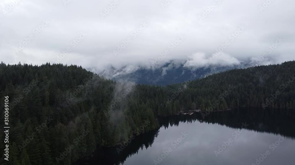 Fly over the lake, forest and through the clouds. With the mountain on the horizon. Fly over the lake, forest and through the clouds. With the mountain on the horizon.