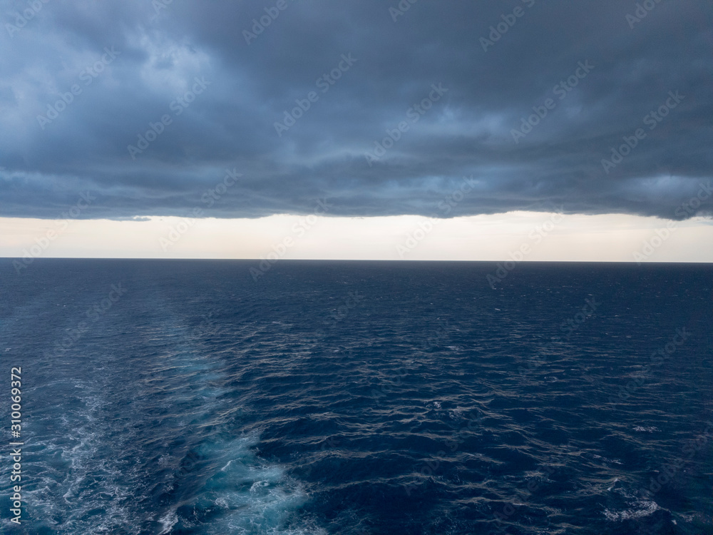 Cloudy weather behind a ship in the ocean