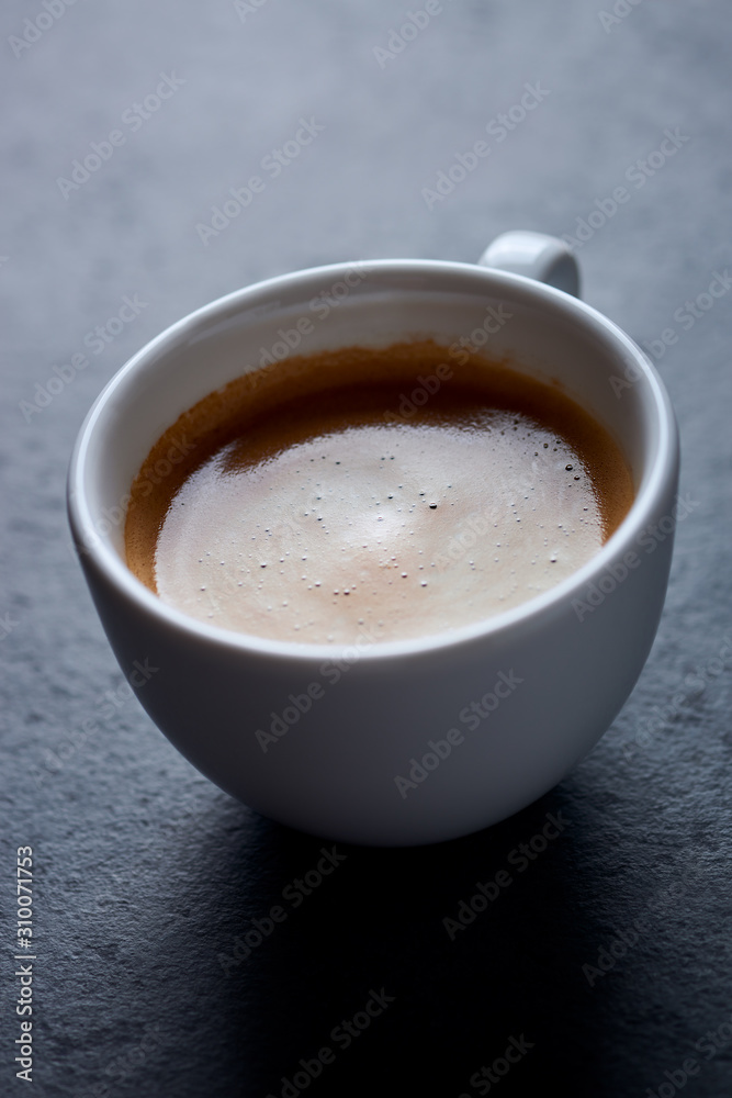 Cup of coffee on dark stone background. Close up. Cup of coffee on dark stone background. Close up.