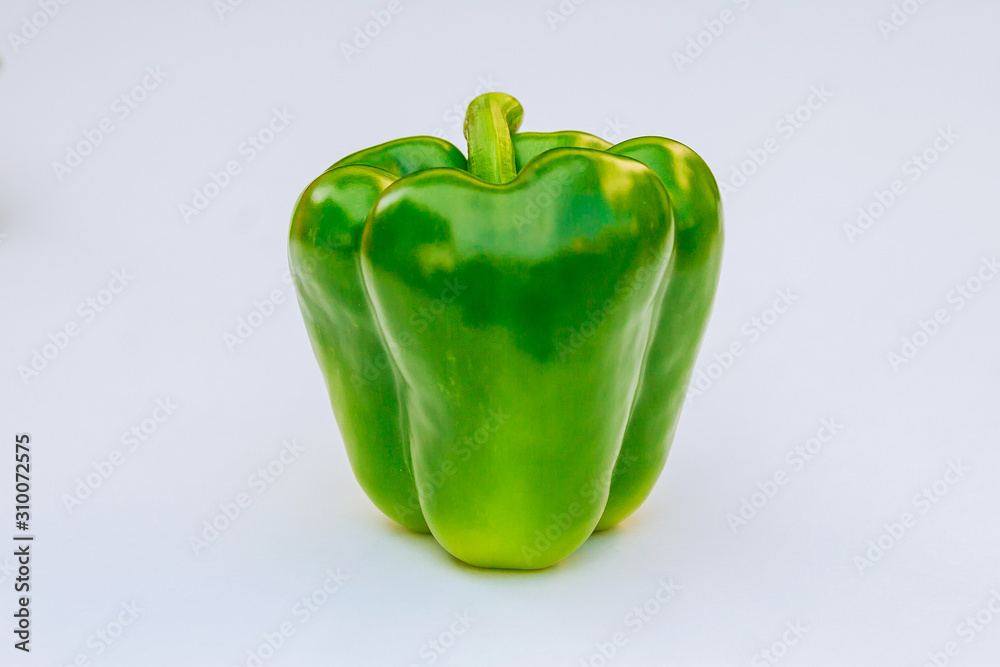 Fresh green bell pepper on a white background. Fresh green bell pepper on a white background.