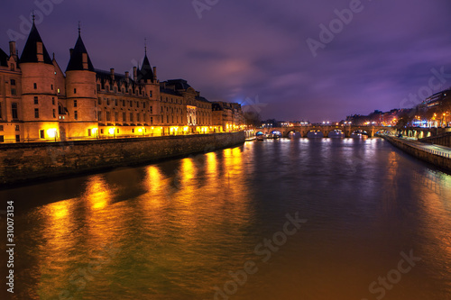 Night view of Conciergerie and Seine river in Paris 