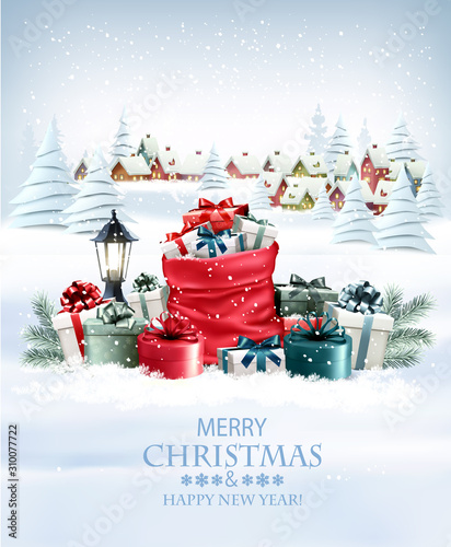 Christmas holiday background with a red sack full presents and a winter village. Vector. © ecco