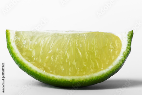 Juicy slice of lime isolated on white, with clipping path