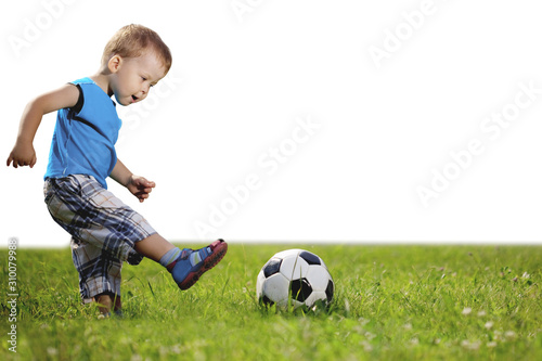 Sports Kid. Baby playing soccer ball in the park. Children play football. Family leisure.