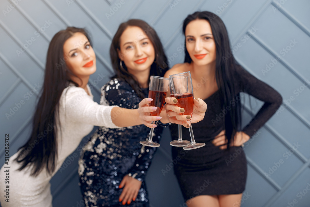 Girls in a studio. Party theme. Ladies in a elegant dress with champagne; Girls in a studio. Party theme. Ladies in a elegant dress with champagne;