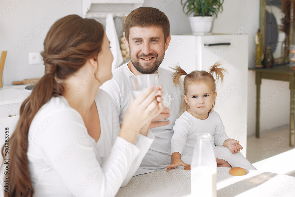 Family in a kitchen. pregnant woman. Little girl with parents. Family in a kitchen. pregnant woman. Little girl with parents.