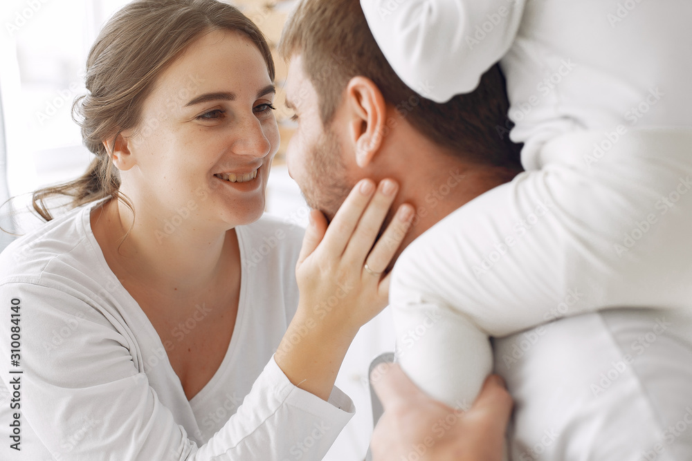Cute little daughter in a white sweater. Family at home in a kitchen. pregnant woman. Cute little daughter in a white sweater. Family at home in a kitchen. pregnant woman.