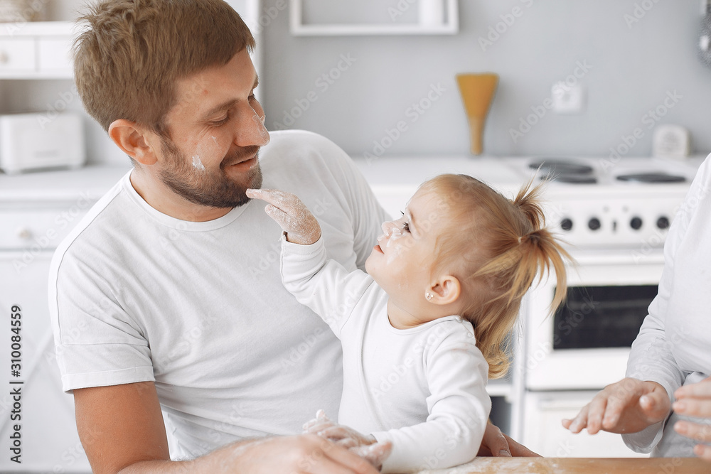 Family in a kitchen. Beautiful mother with little daughter. Family at home Family in a kitchen. Beautiful mother with little daughter. Family at home