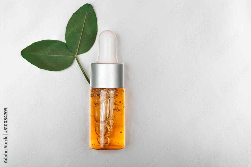 Bottle of beauty oil on silver luxury background Bottle of beauty oil on silver luxury background