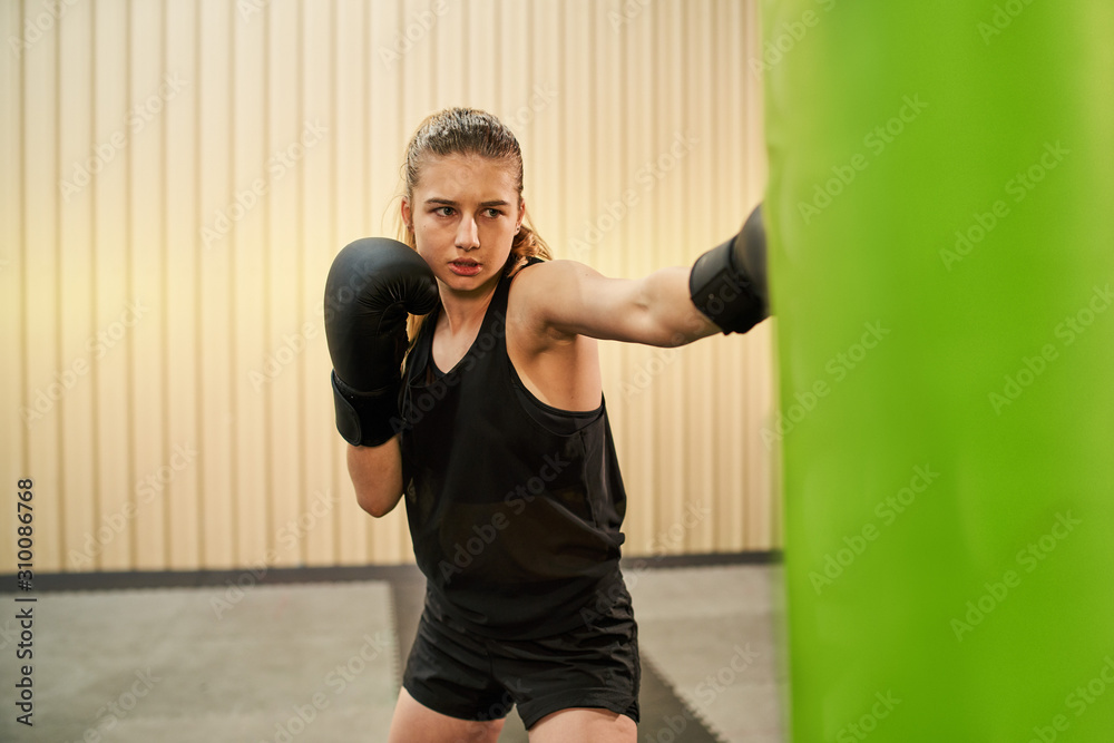 young female keeping fit boxing
