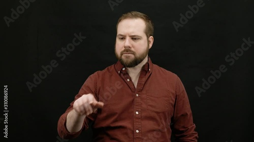 Man expressing emotions on black background