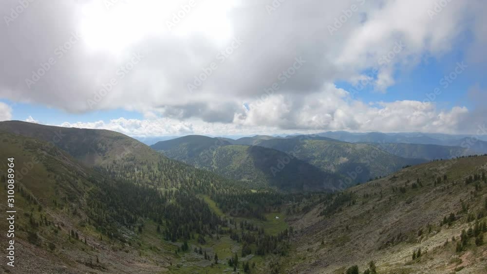 Aerial view of mountain scenery. Flying above the valley surrounded by mountains. Drone flies over the trees. 4K Aerial view of mountain scenery. Flying above the valley surrounded by mountains. Drone flies over the trees. 4K