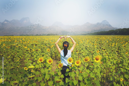 Wallpaper Mural Asian women look like happy on the sunflower garden or sunflowers field Torontodigital.ca