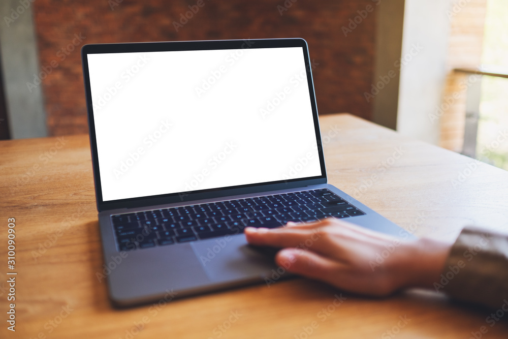 Mockup image of a woman using and touching on laptop touchpad with blank white desktop screen Mockup image of a woman using and touching on laptop touchpad with blank white desktop screen