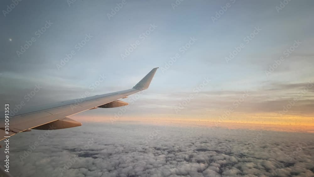 Airplane flying through sky at dusk Airplane flying through sky at dusk