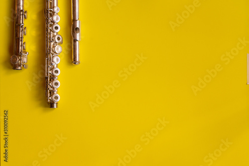 Fotografiet Top view flute traverse over yellow background