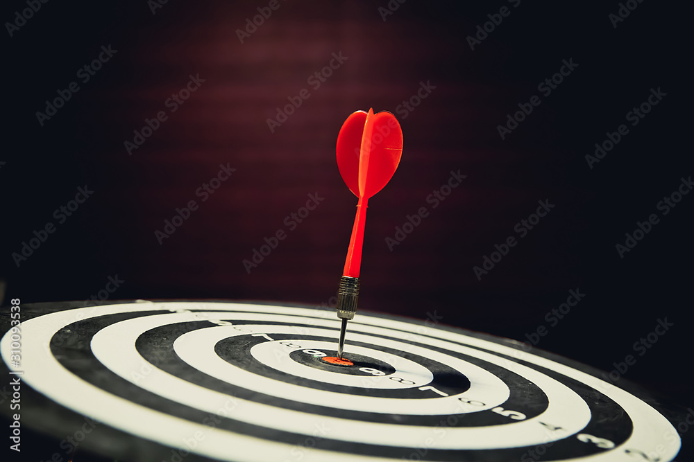 Red dart arrow hitting in the center of bullseye for Business focus concept. Red dart arrow hitting in the center of bullseye for Business focus concept.