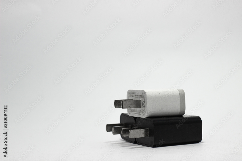 Black and white USB wall charger plug with white background. Black and white USB wall charger plug with white background.