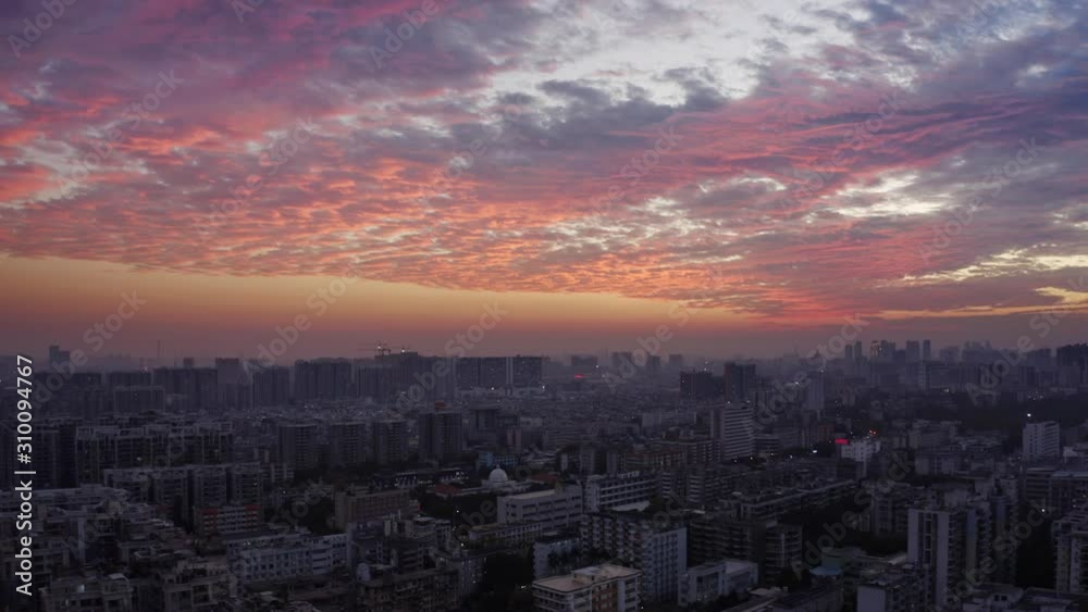 Bird eye view on Guangzhou endless suburb districts during epic red sunset with clouds, China, Guangdong. Bird eye view on Guangzhou endless suburb districts during epic red sunset with clouds, China, Guangdong.