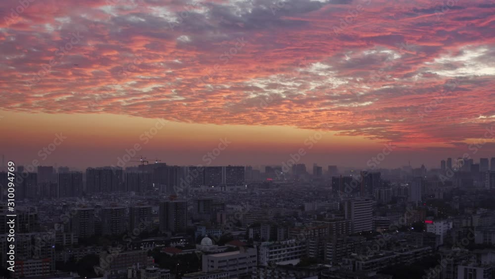 Bird eye view on Guangzhou endless suburb districts during epic red sunset with clouds, China, Guangdong. Bird eye view on Guangzhou endless suburb districts during epic red sunset with clouds, China, Guangdong.