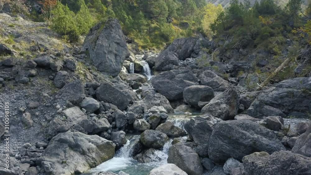 drone hovering above a mountain stream in the austrian alps drone hovering above a mountain stream in the austrian alps