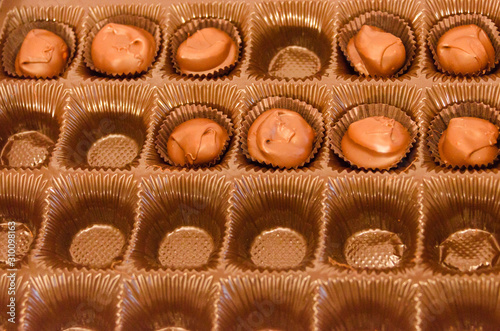 Half empty box of chocolate covered macadamia nuts
