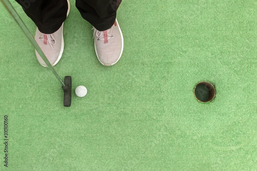 Closing a mini golf hole with the bat and ball