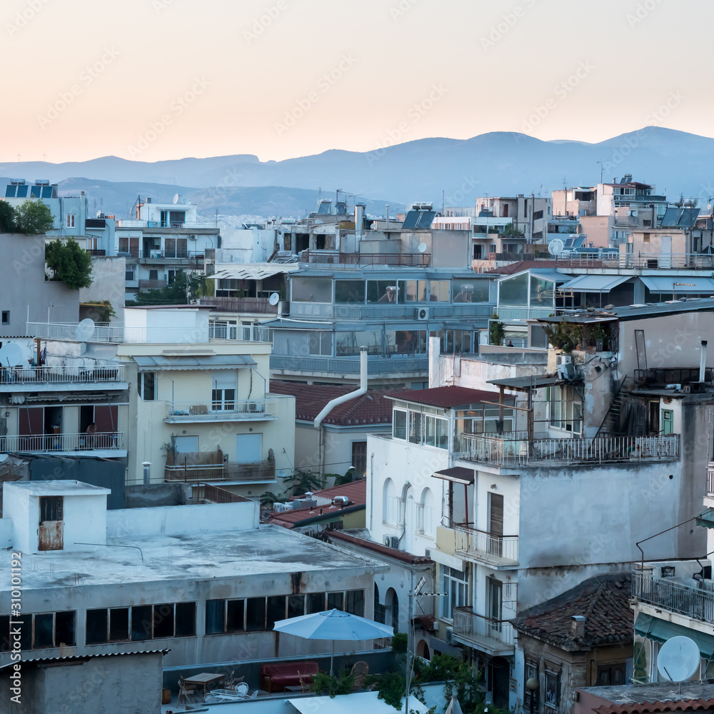 Fototapeta premium Looking across the Athena Athens cityscape in Greece at the Acropolis at sunset