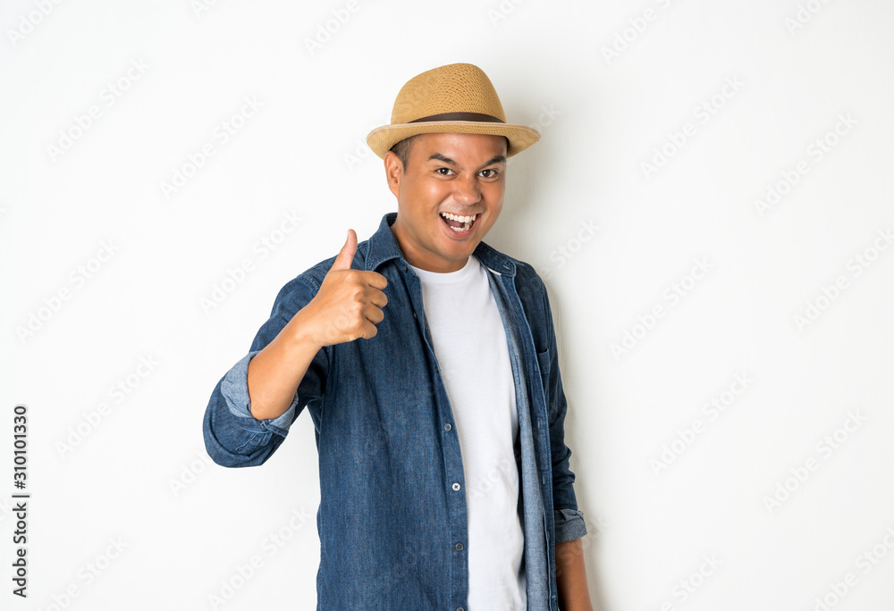 Asian men aged around 30 wearing hats and jeans showing thumb up.