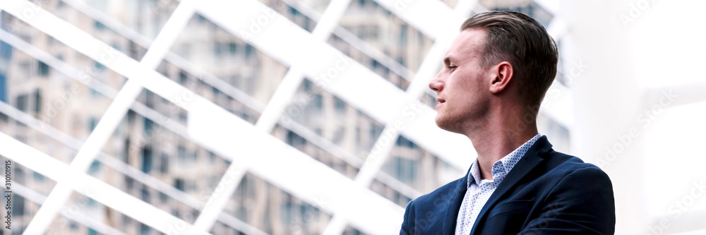 Portrait of handsome man in black suit standing outdoors.Banner with copy space Portrait of handsome man in black suit standing outdoors.Banner with copy space