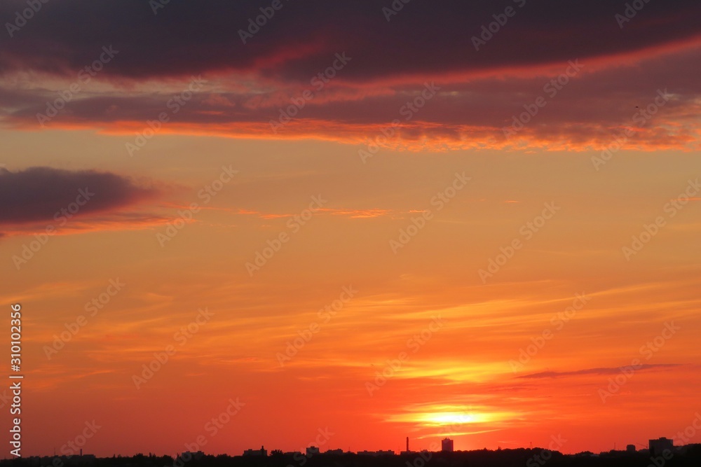 Beautiful orange burgundy sunset over the city, natural background 
