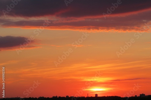 Beautiful orange burgundy sunset over the city, natural background  © natalya2015