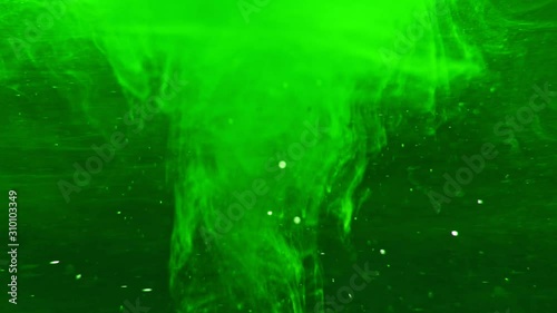 Paint fall into water which is twist. Spin acrylic ink drip into liquid. Visual effect bullet time, frozen moment, flow motion. Cloud fraction of color is spray drop. Slow motion cosmic video magic. photo