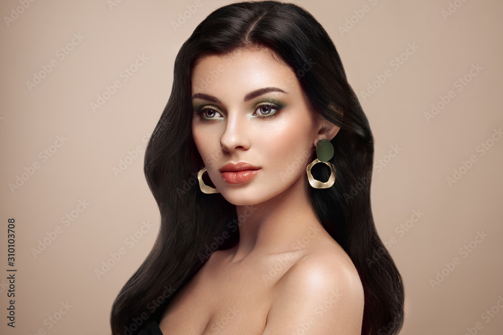 Beautiful woman with long curly hair. Girl with perfect makeup and ...